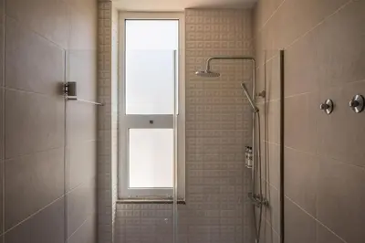 a bathroom with a shower and a window at PortoTile By RDC in Porto