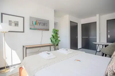 a bedroom with a bed with two towels on it at Liiiving in Porto - City Design Studios in Porto