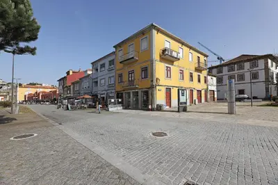 a city street with a yellow building on the corner at FLH Gaia Wine Cellars Flat in Vila Nova de Gaia
