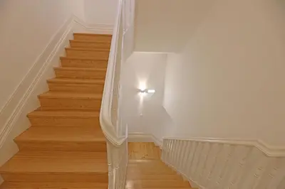 a white staircase with a light on the wall at FLH Porto Santa Catarina Duplex in Porto