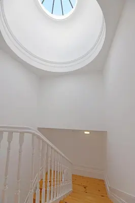 a room with a white ceiling with a spiral staircase at FLH Porto Santa Catarina Duplex in Porto