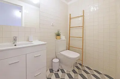 a bathroom with a toilet and a sink at FLH Porto Santa Catarina Duplex in Porto