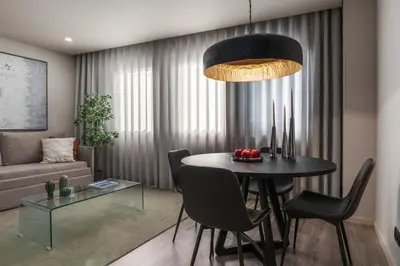 a living room with a table and chairs and a couch at City Luxury Apartment, Downtown Porto near Metro in Porto