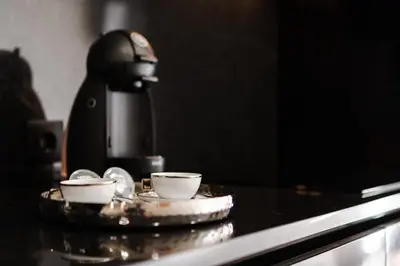 a coffee machine with two cups on a counter at City Luxury Apartment, Downtown Porto near Metro in Porto