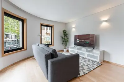 a living room with a couch and a flat screen tv at GuestReady - Artsy Apartment in Porto