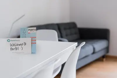 a living room with a white table and white chairs at GuestReady - Artsy Apartment in Porto