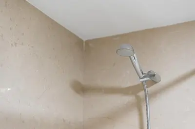 a shower head in a corner of a bathroom at GuestReady - Artsy Apartment in Porto