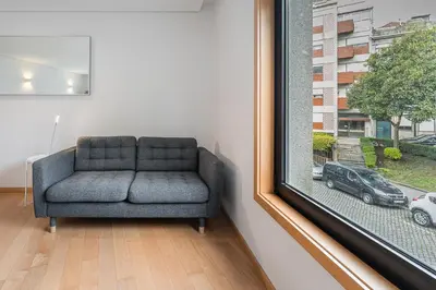 a chair sitting in a room next to a window at GuestReady - Artsy Apartment in Porto