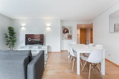 a living room with a couch and a table with chairs at GuestReady - Artsy Apartment in Porto