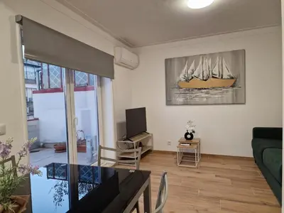 a living room with a couch and a tv at Pretty flat with terrace, air cond, free parking, by Porto with Love LDA in Porto