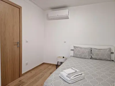 a bedroom with a bed with a gray comforter at Pretty flat with terrace, air cond, free parking, by Porto with Love LDA in Porto