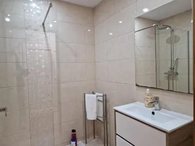 a white bathroom with a sink and a shower at Pretty flat with terrace, air cond, free parking, by Porto with Love LDA in Porto