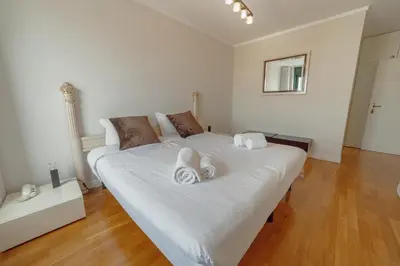 a bedroom with a large white bed with towels on it at Downtown Grand Tower View by Vacationy in Porto