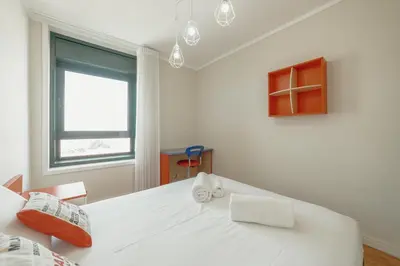 a white room with a large white table and a window at Downtown Grand Tower View by Vacationy in Porto