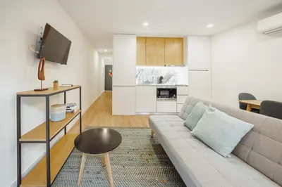 a living room with a couch and a table at Courtyard Oporto Design Apartments by Vacationy in Porto
