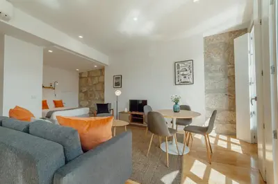 a living room with a couch and a table at Courtyard Oporto Design Apartments by Vacationy in Porto