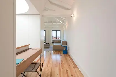 an office with white walls and a desk and chairs at Boavista Penthouse w/ 2 Balconies & AC by LovelyStay in Porto