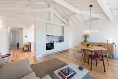 a living room and kitchen with a table and chairs at Boavista Penthouse w/ 2 Balconies & AC by LovelyStay in Porto