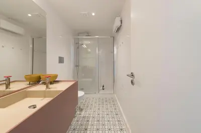 a bathroom with a shower and a toilet at Boavista Penthouse w/ 2 Balconies & AC by LovelyStay in Porto