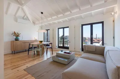a living room with a couch and a table at Boavista Penthouse w/ 2 Balconies & AC by LovelyStay in Porto