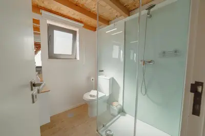 a bathroom with a shower and a toilet at Mezzanine Stylish Apartments by Vacationy in Porto