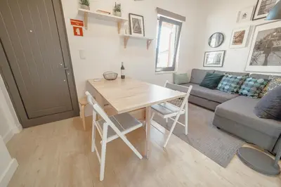 a living room with a table and a couch at Mezzanine Stylish Apartments by Vacationy in Porto
