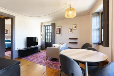 a living room with a table and chairs at Feel Porto Antique Poveiros Flats in Porto