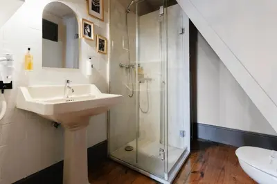 a bathroom with a sink and a glass shower at Feel Porto Antique Poveiros Flats in Porto