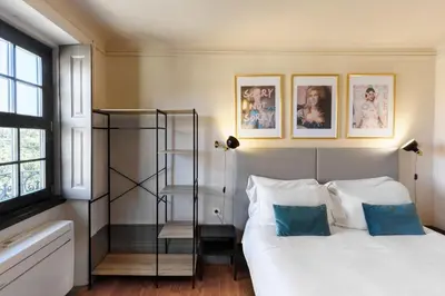 a bedroom with a bed and some pictures on the wall at Feel Porto Antique Poveiros Flats in Porto