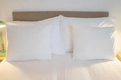 two white pillows on a bed in a room at Fancy Ribeira Porto in Porto