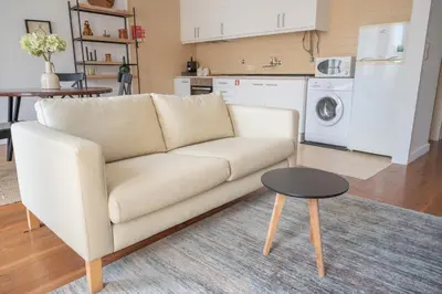 a living room with a white couch and a table at Fancy Ribeira Porto in Porto