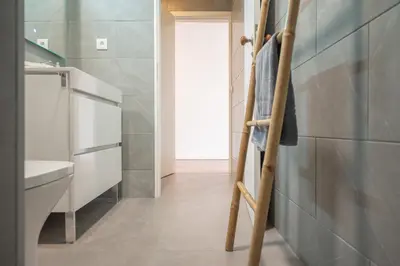 a bathroom with a ladder next to a refrigerator at Fancy Ribeira Porto in Porto