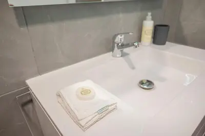 a bathroom sink with a towel and a faucet at Fancy Ribeira Porto in Porto