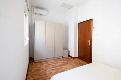 a bedroom with a white bed and a closet at Downtown A whole house duplex designed for remote work and near metro lapa in Porto