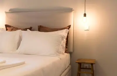 a bedroom with a bed and a table and a kitchen at Porto Central Loft I with Terrace in Porto