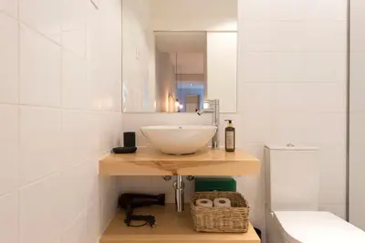 a small room with a bench and a mirror at Porto Central Loft I with Terrace in Porto