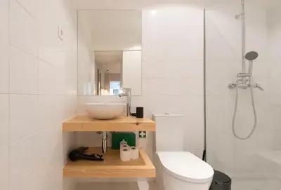 a bedroom with a bed and a table and a kitchen at Porto Central Loft II in Porto