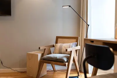 a desk with a mirror and a lamp and a chair at Porto Central Loft II in Porto