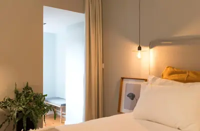 a desk with a lamp and a chair in a room at Porto Central Loft II in Porto