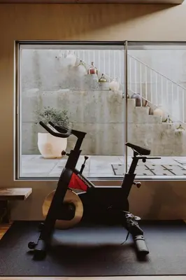 a gym with a treadmill next to a staircase at Village By BOA in Porto