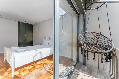 a room with a swinging bed and a chair at GuestReady - Urban Retreat in Gaia in Vila Nova de Gaia