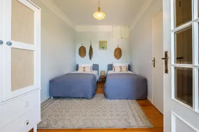 two beds in a room with a door at Santa Catarina Panoramic Loft in Porto