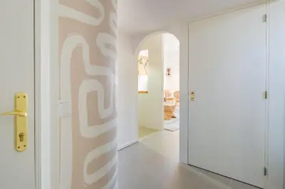 a hallway with a white wall with a door at Santa Catarina Panoramic Loft in Porto