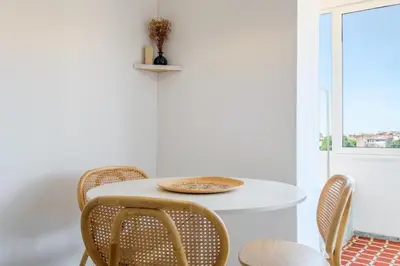 a white table with chairs and a plate on it at Santa Catarina Panoramic Loft in Porto
