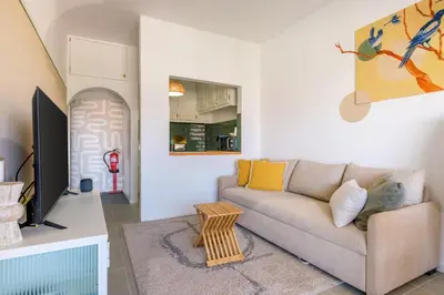a living room with a couch and a tv at Santa Catarina Panoramic Loft in Porto