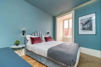 a living room with a gray couch with red pillows at Infante Apartment by Amber Star Rent in Porto