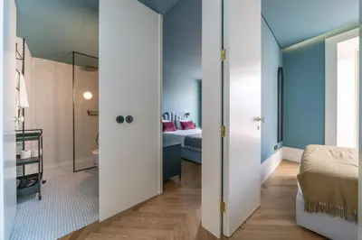 a bedroom with a white bed and a window at Infante Apartment by Amber Star Rent in Porto
