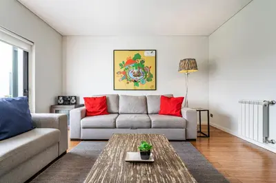 a living room with a hard wood floor and a hallway at Art City Villa in Porto