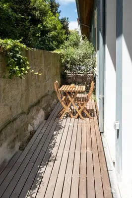 a wooden bench sitting on a wooden deck at Oporto INNside House in Porto