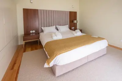 a bedroom with a large bed with white sheets and pillows at Oporto INNside House in Porto